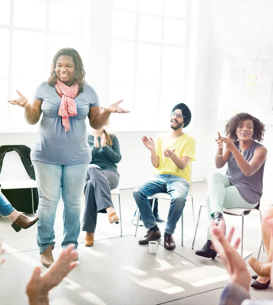 CTI-DEI-2 woman standing in front of clapping group