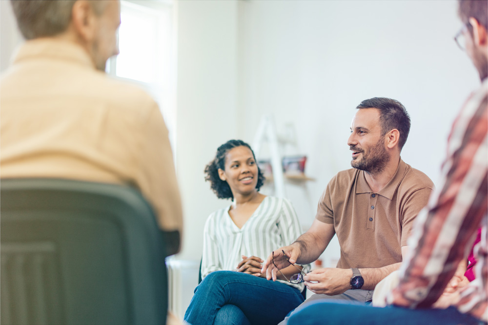 man speaking in a group circle