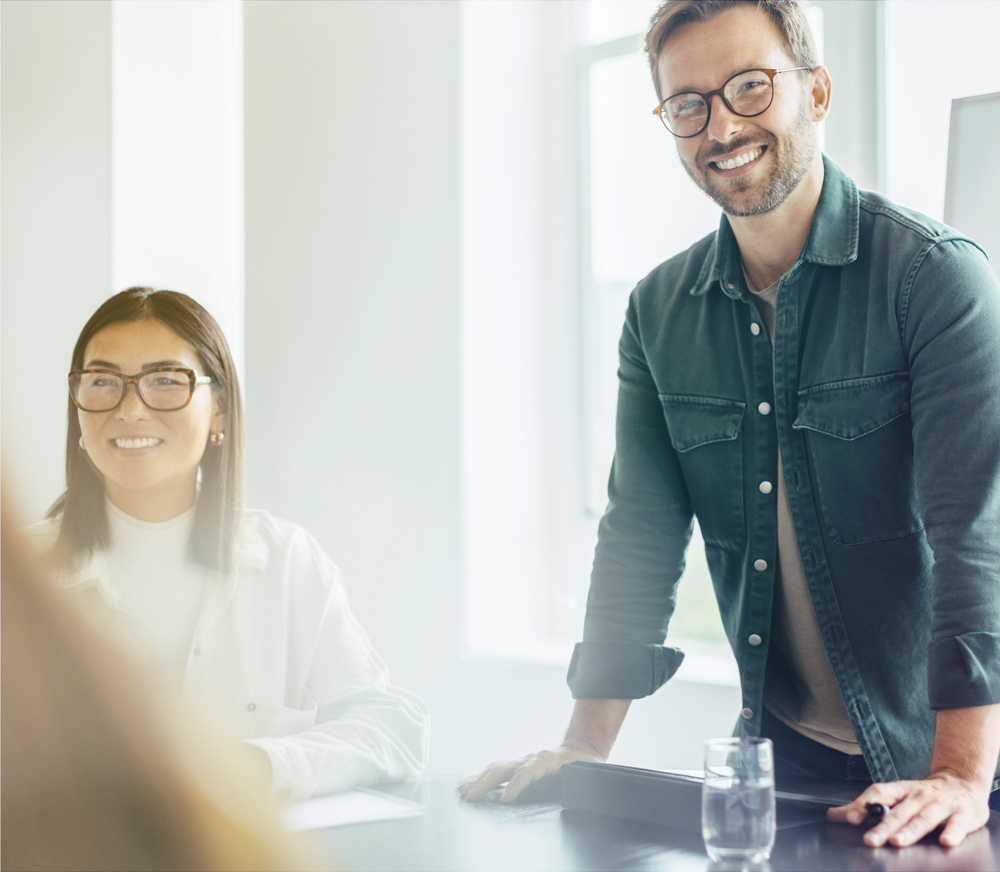 man standing by table at meeting