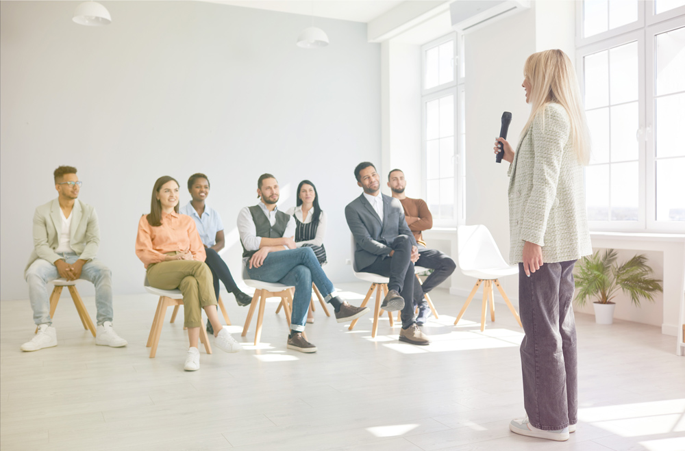 woman standing in front of clapping group