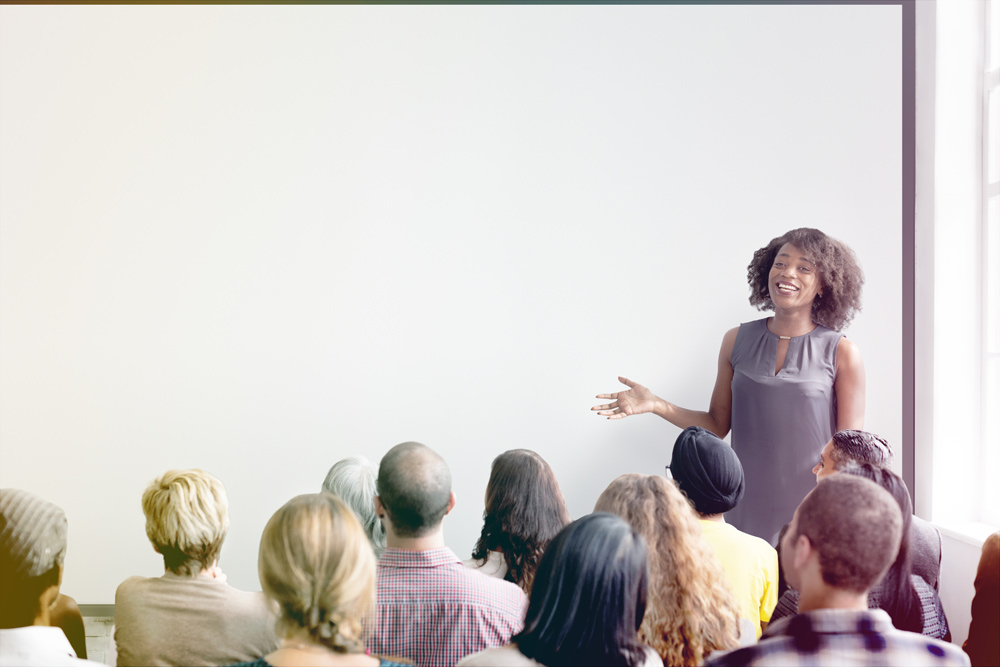 woman speaking in front of a group