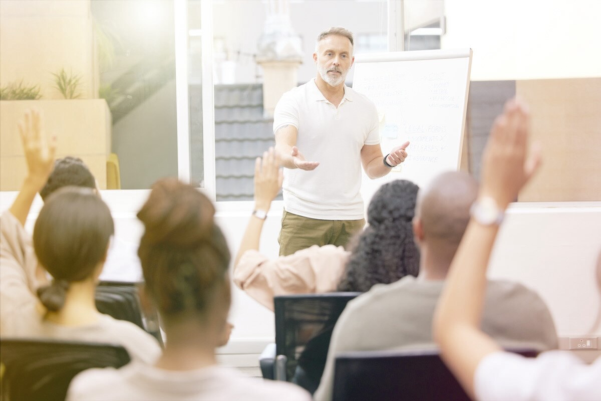 A man confidently leads a group of peers.