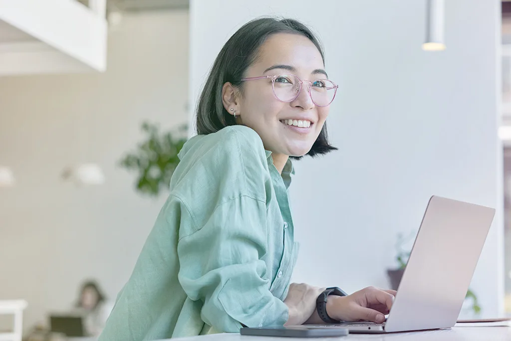 Fundamentals-1 Woman smiling working on computer