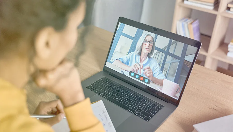 woman watching webinar on laptop