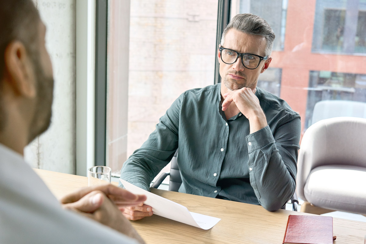 Coach attentively listening to client during one-on-one meeting