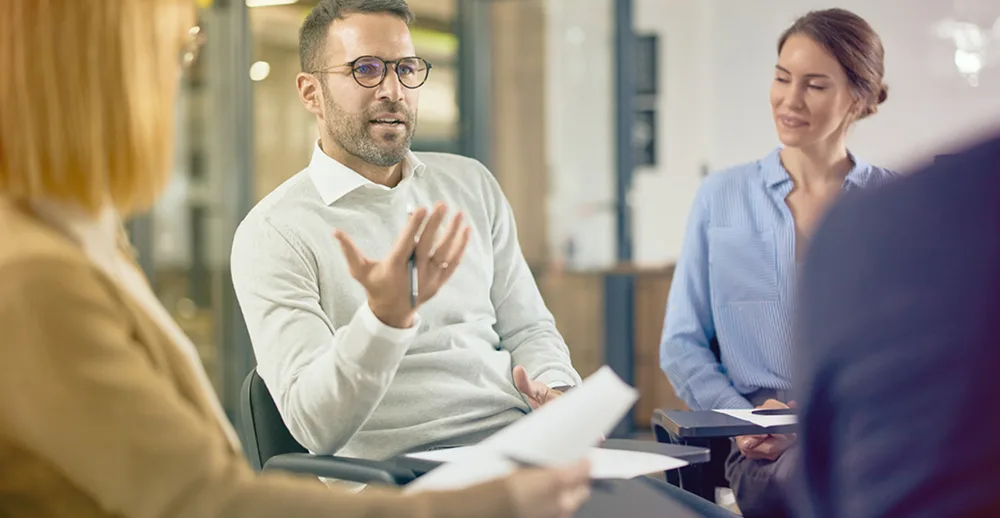 co-workers talking in office setting