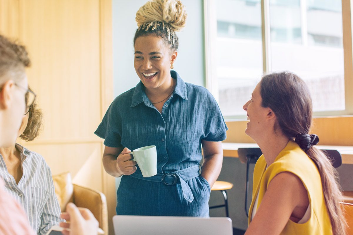 Smiling woman engaging with friends.