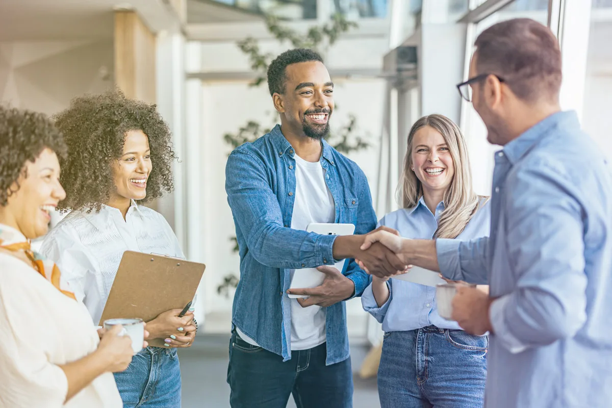 man in group shaking hands