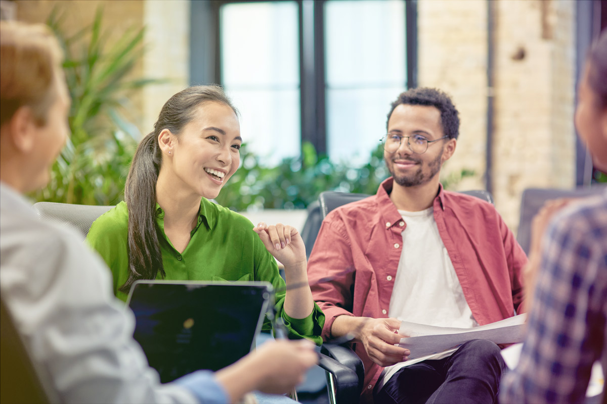 A team of people sitting together in a meeting
