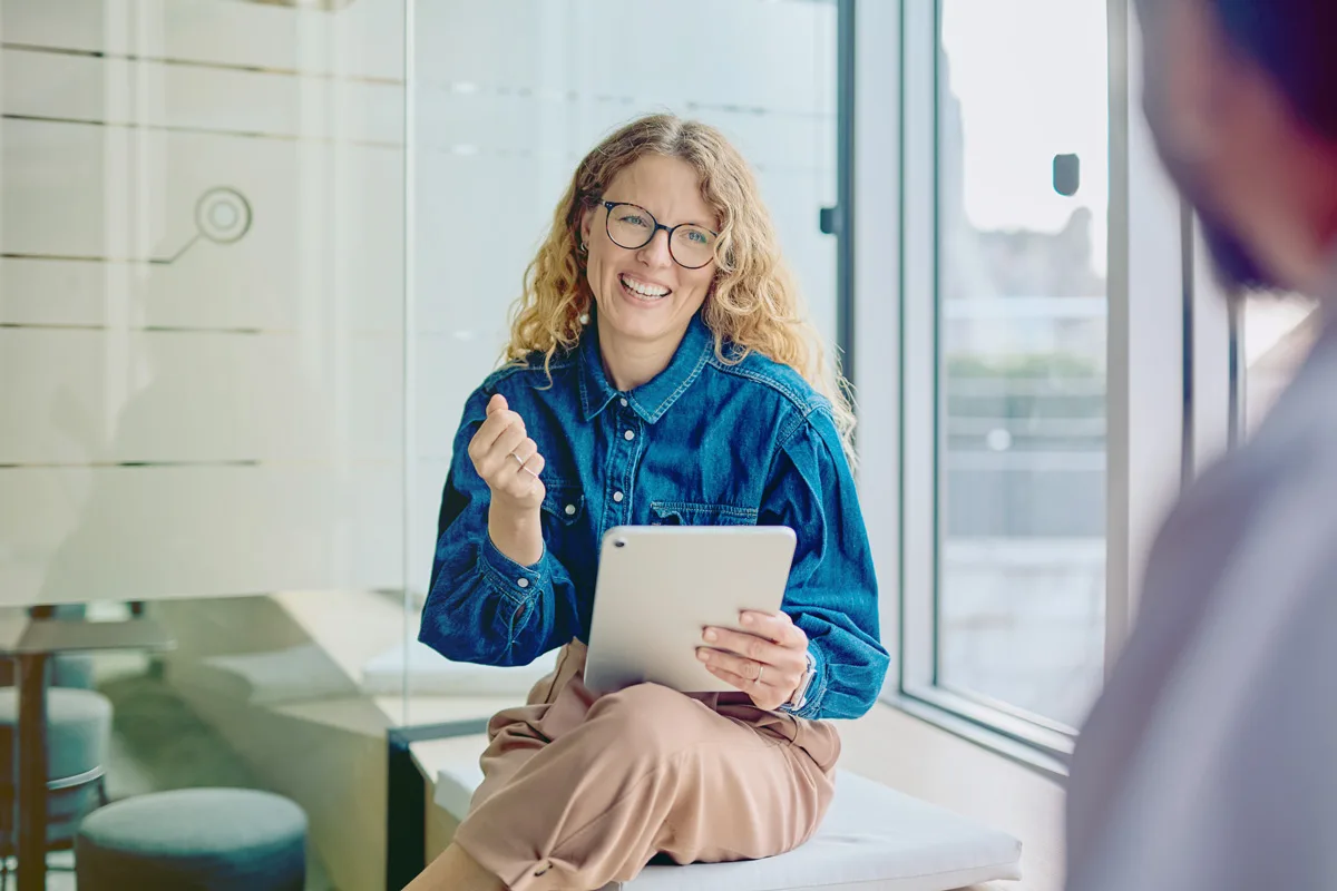 Lady in blue shirt holding a tablet