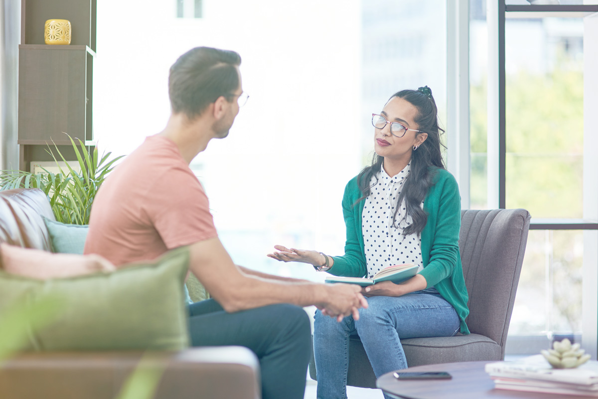 Two people engaged in conversation indoors.