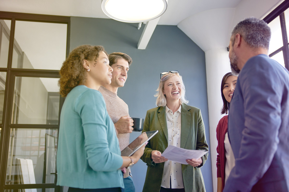 Group of professionals having a discussion in an office.