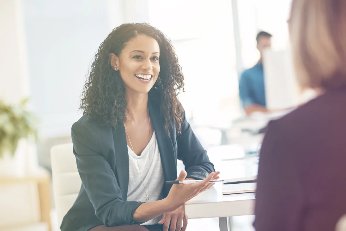 Woman speaking with an employee in an office.