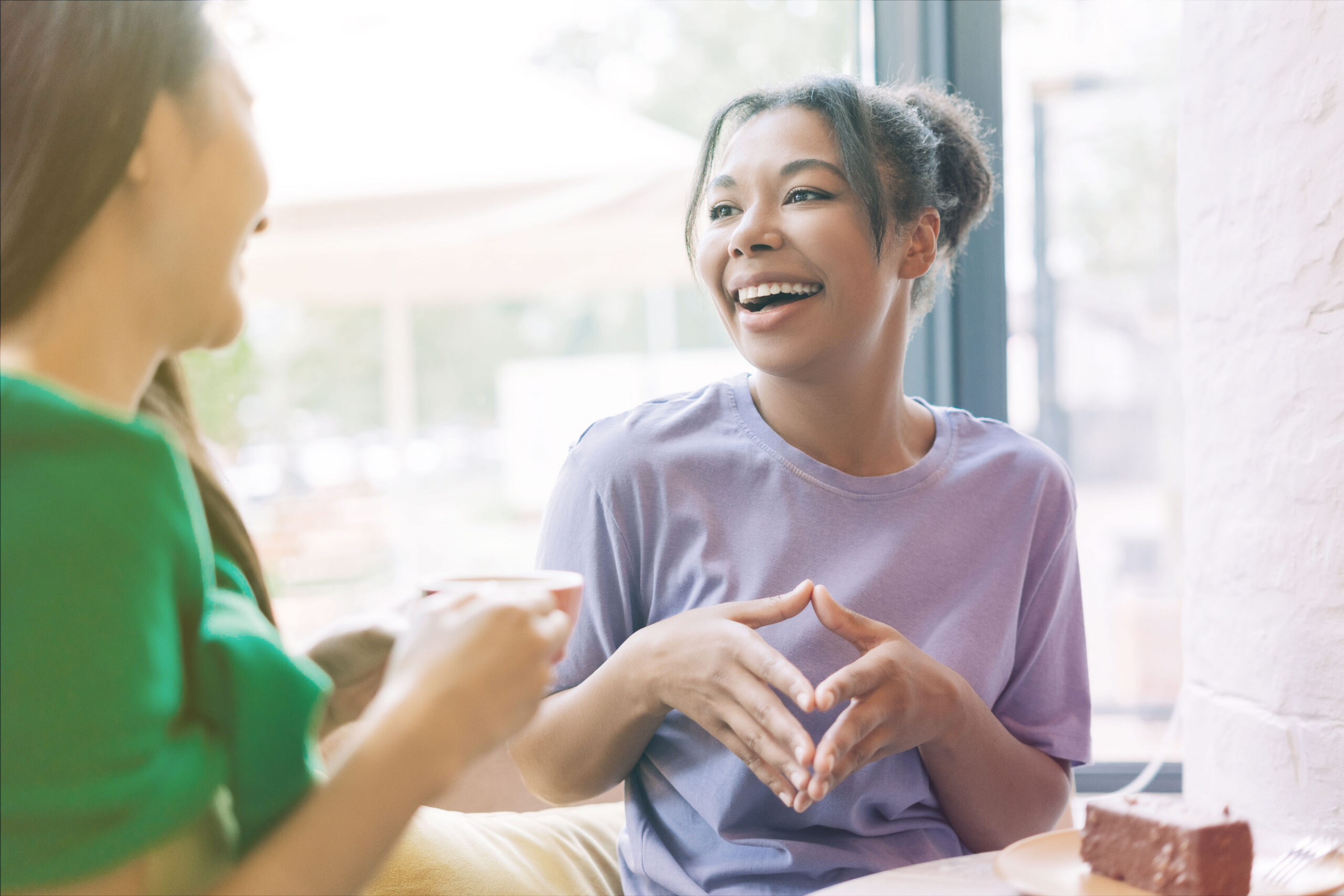 Two people having a conversation over coffee