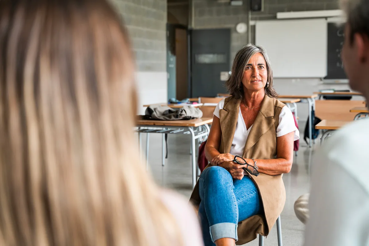 2026_02_CTI_Thought-Leadership-Article-1of4 Woman sitting in a classroom with two people in the foreground.