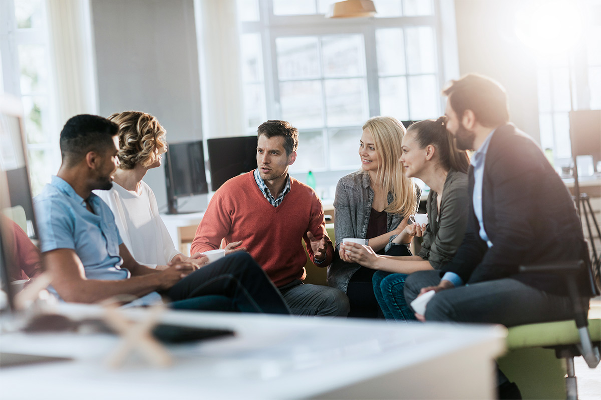 Group of professionals sitting in a circle during a discussion.