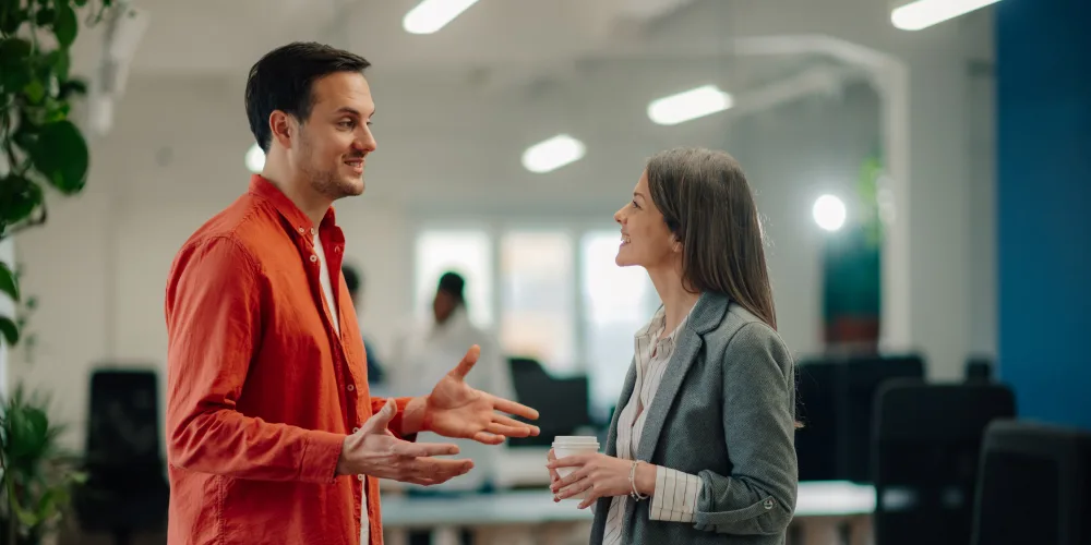co-workers talking in office setting