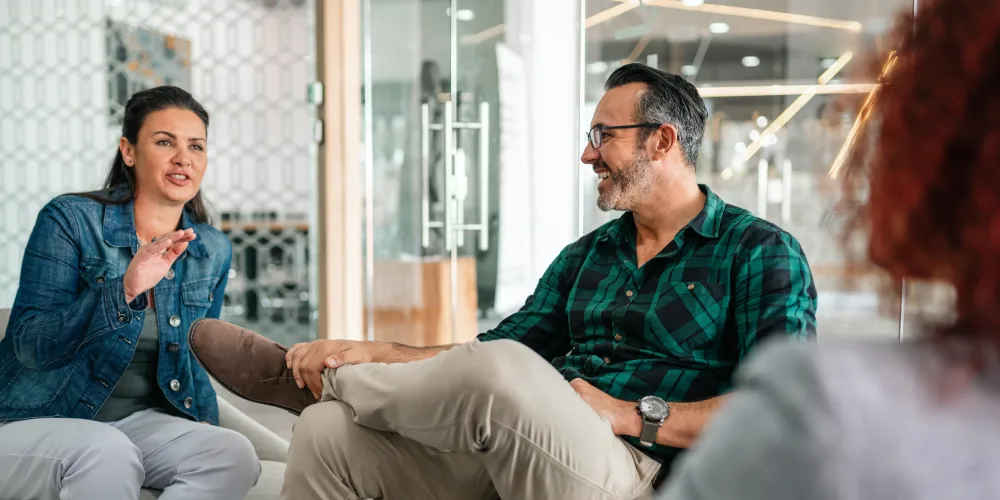 co-workers converse in casual setting