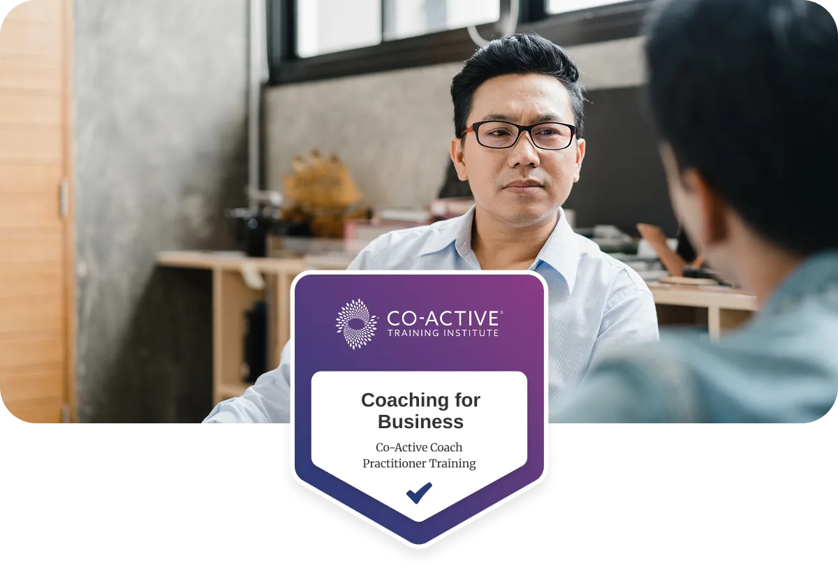 co-workers talking in office with Coaching for Business badge overlayed.