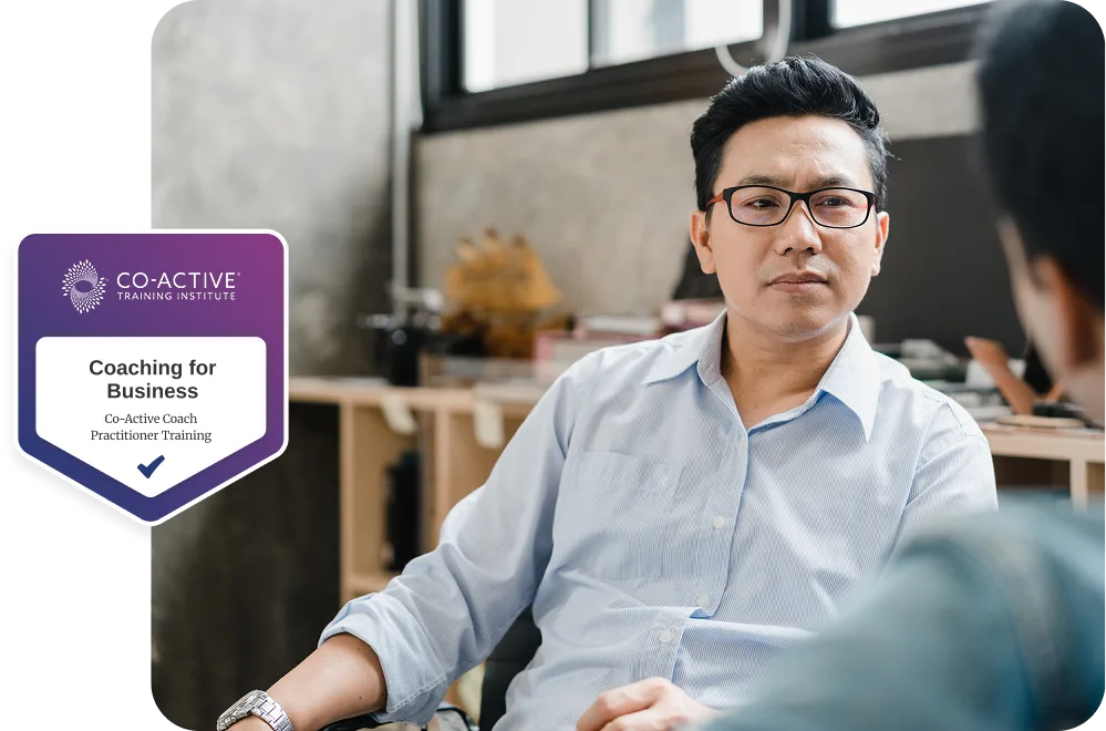 co-workers talking in office with Coaching for Business badge overlayed.
