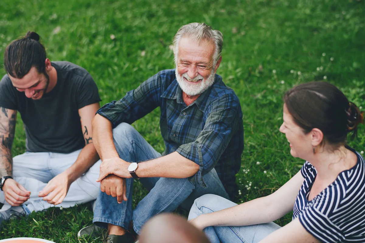 Group of people laughing outdoors together