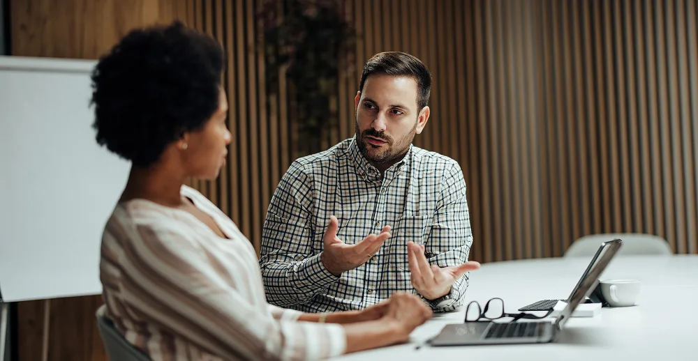 Two people discussing in an office