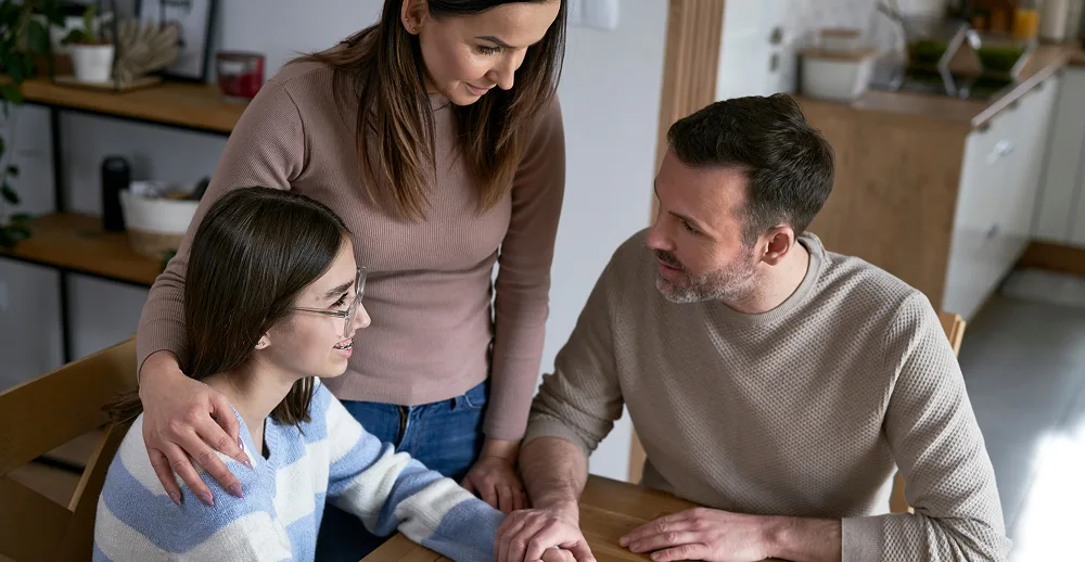Family interacting at a table.