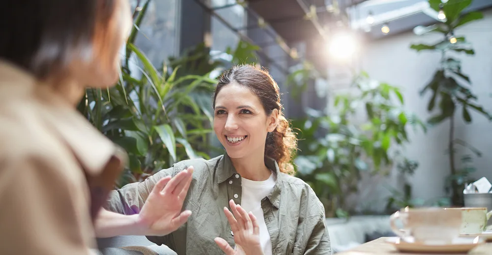 Two women chatting in a cafe.