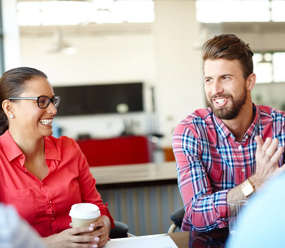 Two people smiling in a meeting