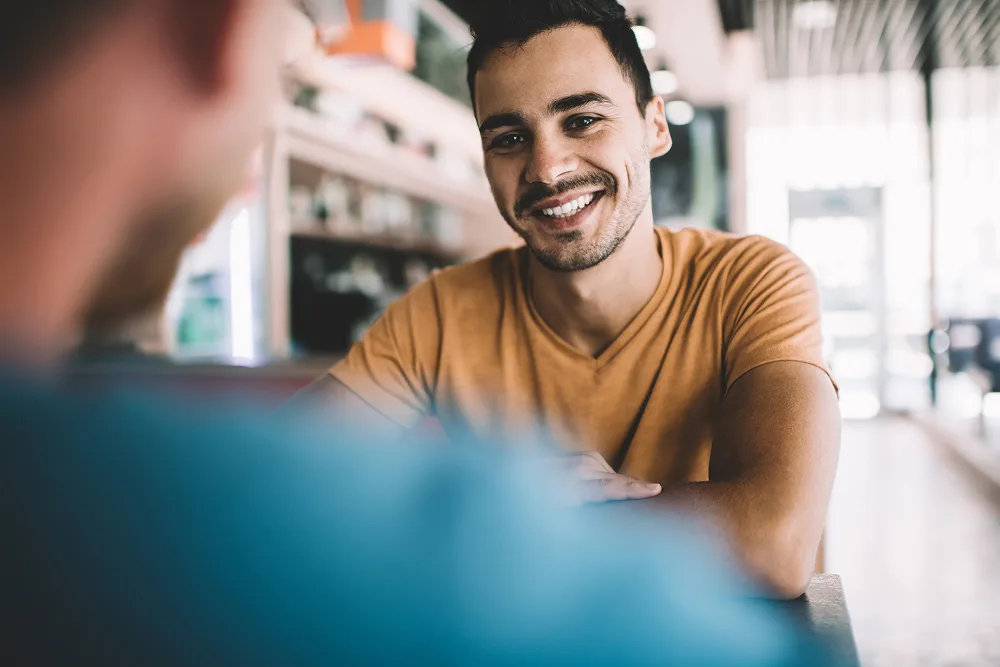 two men talking at coffee shop
