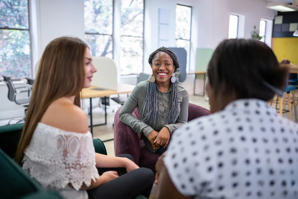 Three women engaged in conversation