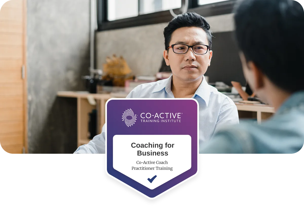 co-workers talking in office with Coaching for Business badge overlayed.