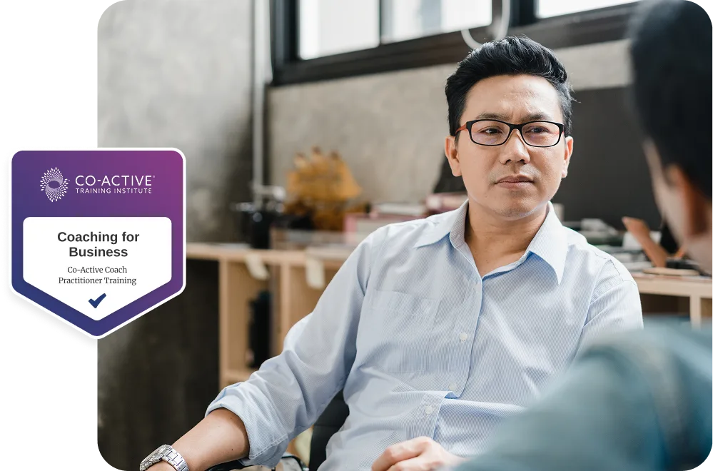 co-workers talking in office with Coaching for Business badge overlayed.
